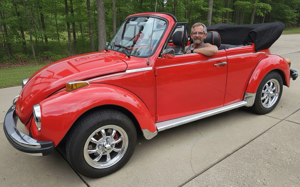 VW Super Beetle and its proud owner onboard