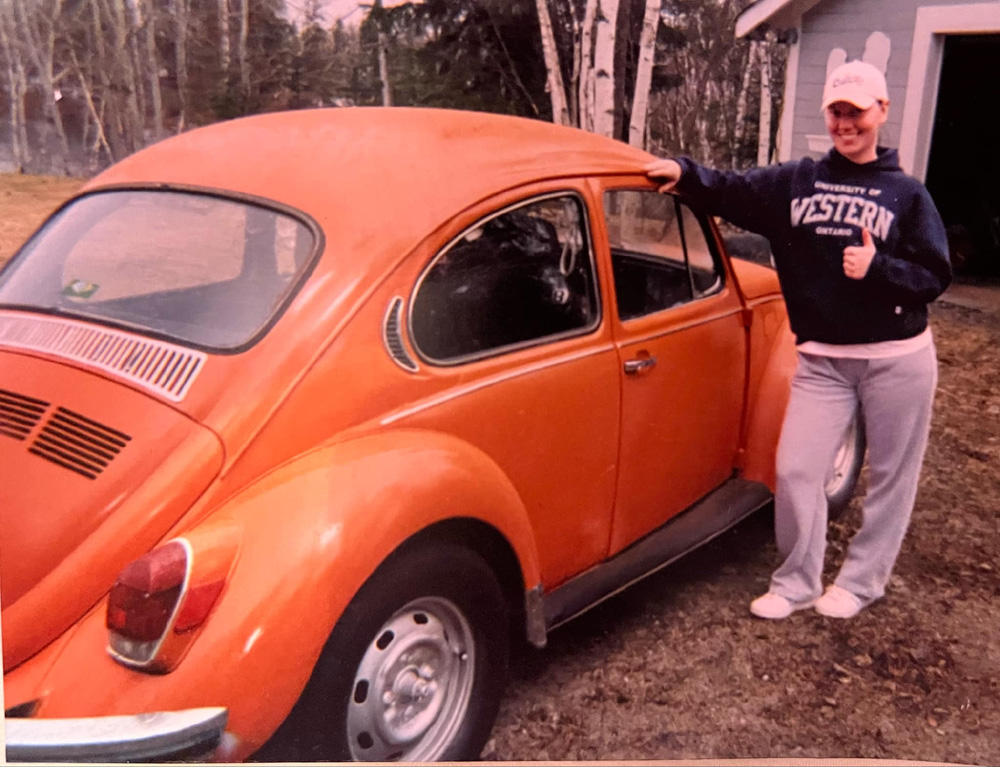 Super Beetle sedan in orange was her first VW