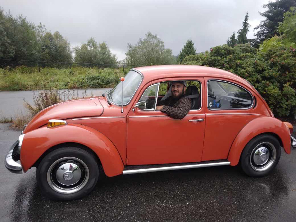Volkswagen Super Beetle with its owner driving