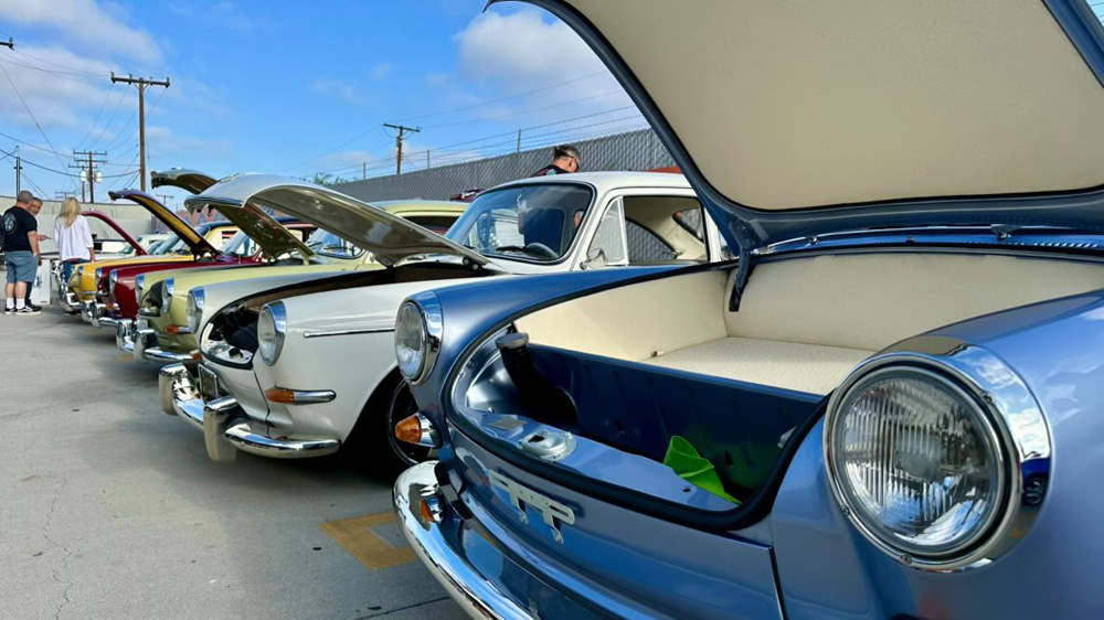Lineup of Volkswagen Type 3 models with open front trunks at the EMPI 70th Anniversary Open House