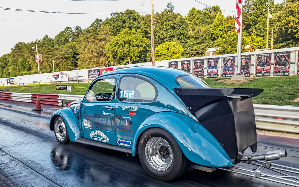 Blue drag Beetle named Bad Behavior launching on the strip with sponsor banners